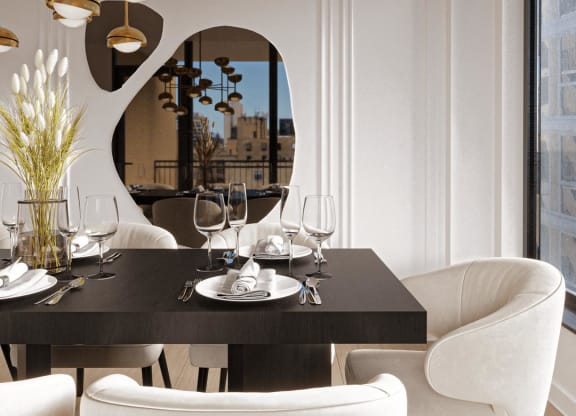 a dining room with white chairs and a black table at Chateau on Wells, Chicago, IL