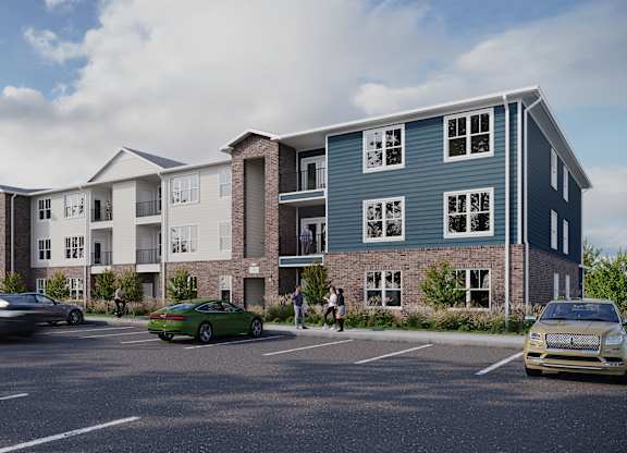 A rendering of a modern apartment complex with cars parked in the lot.
