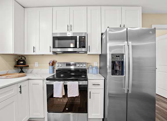 a kitchen with stainless steel appliances and white cabinets