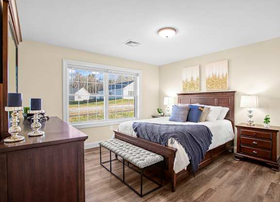 a bedroom with a large bed and a window