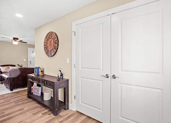 a living room with white closets and a couch and a table