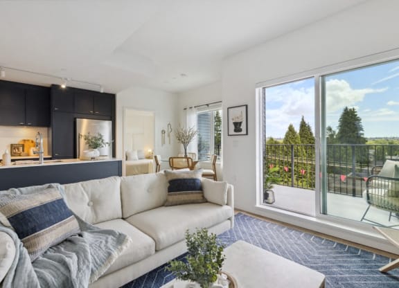 a living room with a white couch and a large window