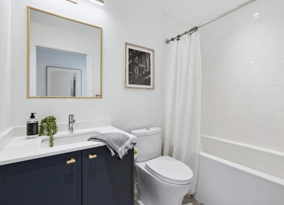 a bathroom with a toilet and a sink and a bath tub