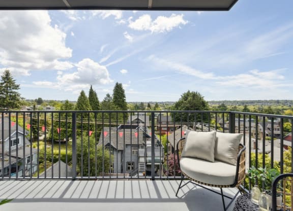a balcony with a chair and a view of houses