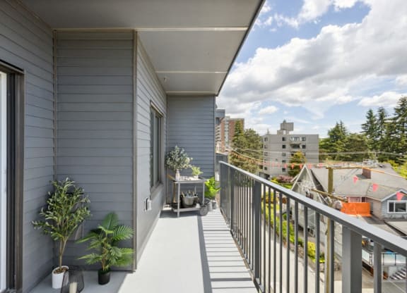 a balcony with a view of a city and a house