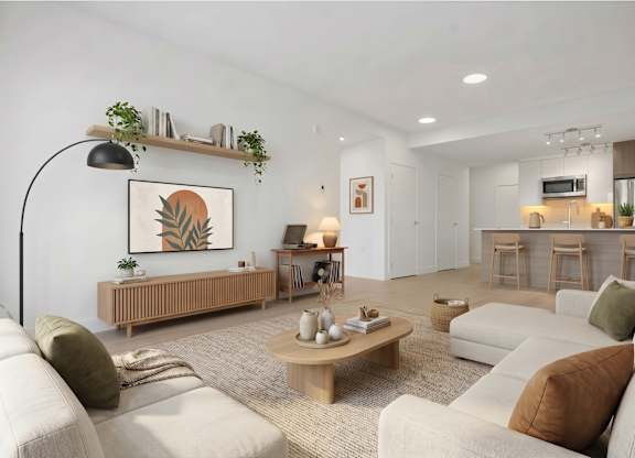 A living room with a white couch, a wooden coffee table, and a painting on the wall.