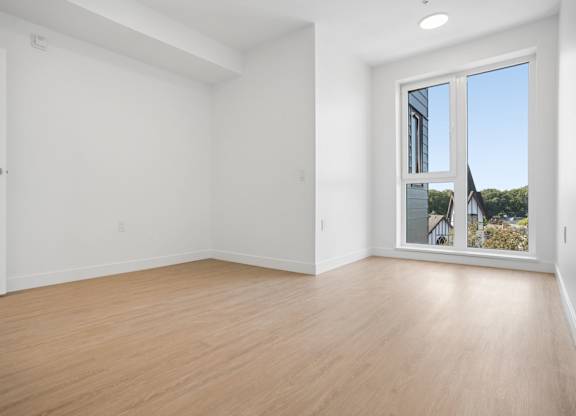 A large empty room with a sliding glass door.