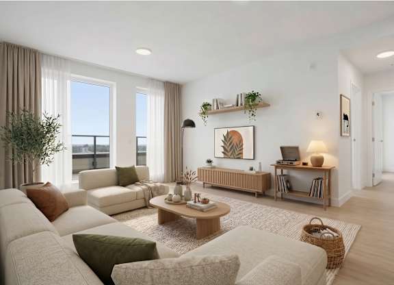A living room with a white couch, a wooden coffee table, and a large window with curtains.