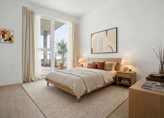 A bedroom with a large bed and a painting on the wall.