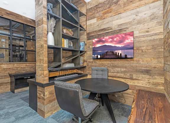 A modern living room with a fireplace and a large painting on the wall  at Bridges at Flatiron, Broomfield, 80021