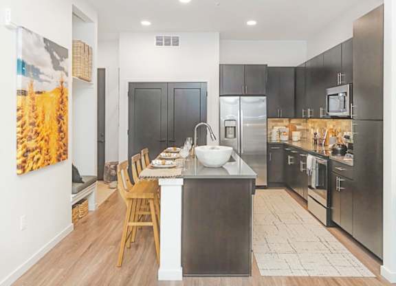 A modern kitchen with a dining table and chairs  at Bridges at Flatiron, Broomfield, 80021
