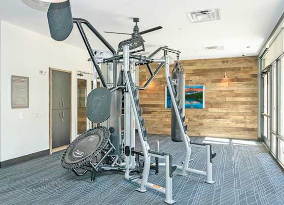 A gym with a weight bench, a weight rack and a fan  at Bridges at Flatiron, Broomfield, 80021