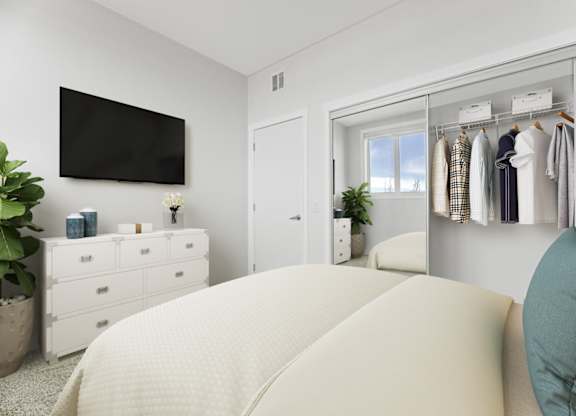 A bedroom with a large bed and a wardrobe with clothes hanging on it.