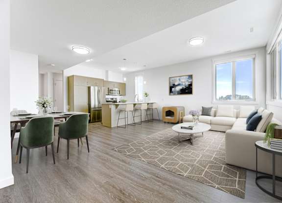 A modern living room with a dining area and a kitchen in the background.