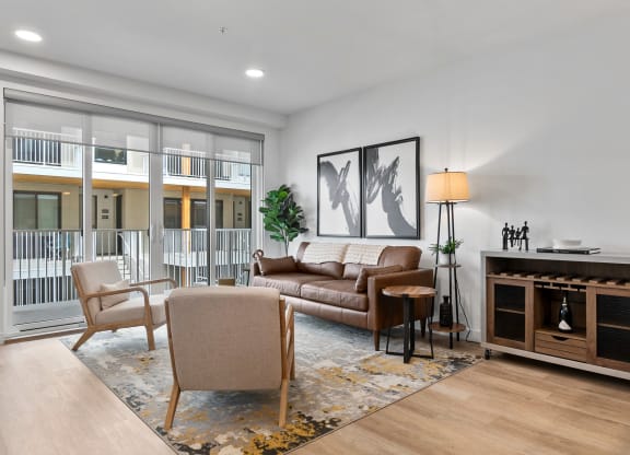a living room with a couch chairs and a fireplace