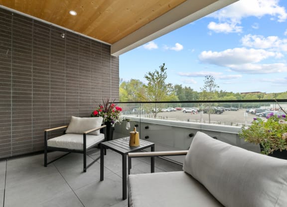 a balcony with two chairs and a table