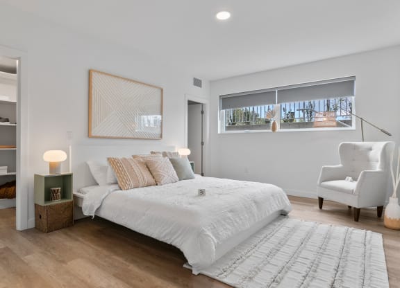 a bedroom with a bed and a chair