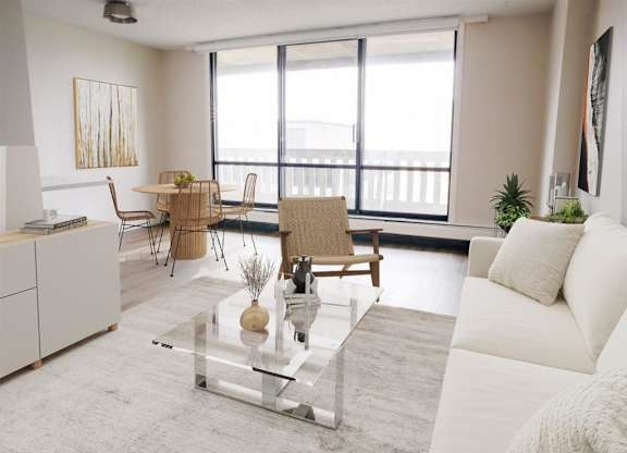 a living room with a white couch and a glass table