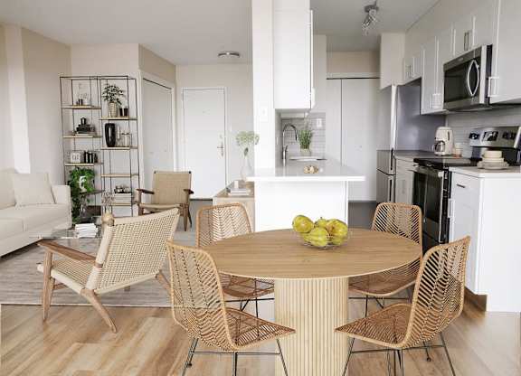 a living room and kitchen with a table and chairs