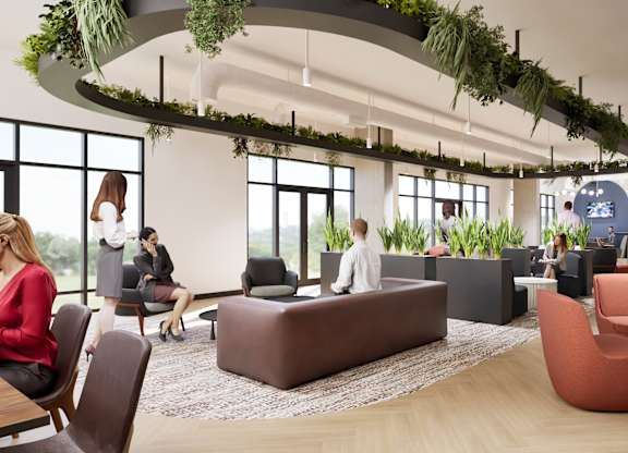 A modern office space with people working and sitting around.