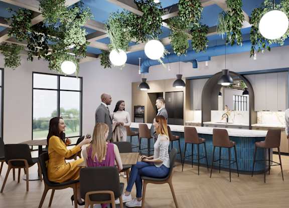 A group of people are gathered in a modern, open-plan office space.