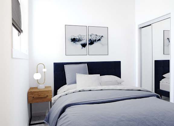 A bedroom with a bed, nightstand, and a painting on the wall.
