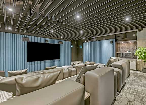A modern home theater with a large screen and comfortable seating.