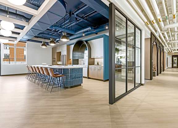 A long hallway with a table and chairs on the left.