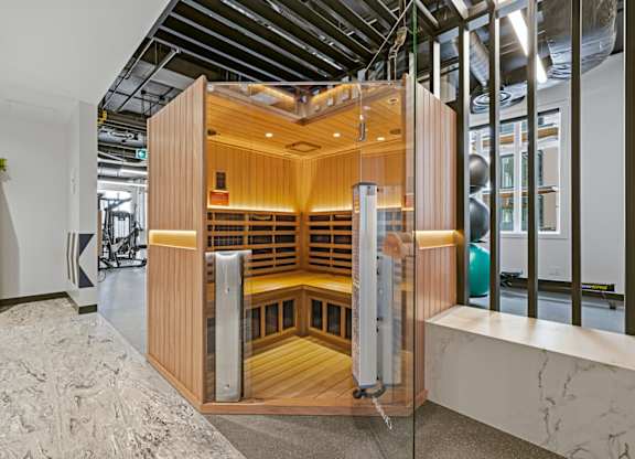 A wooden room with a glass door is shown.