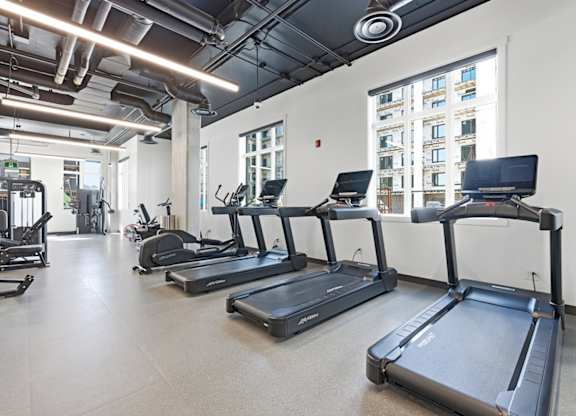 A gym with treadmills and other exercise equipment.