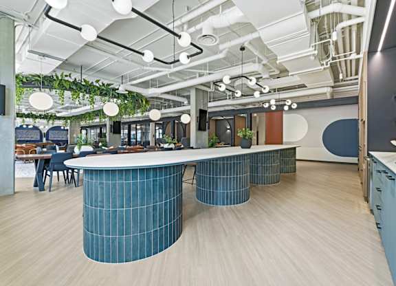A modern office space with a curved table in the center.