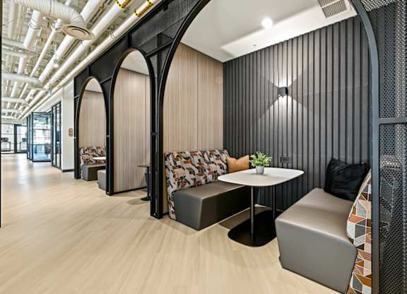 A modern office space with wooden floors and black accents.