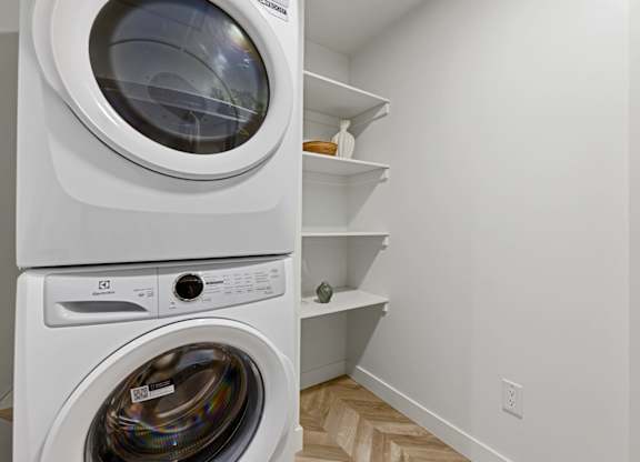 A white washing machine and dryer in a small laundry room.
