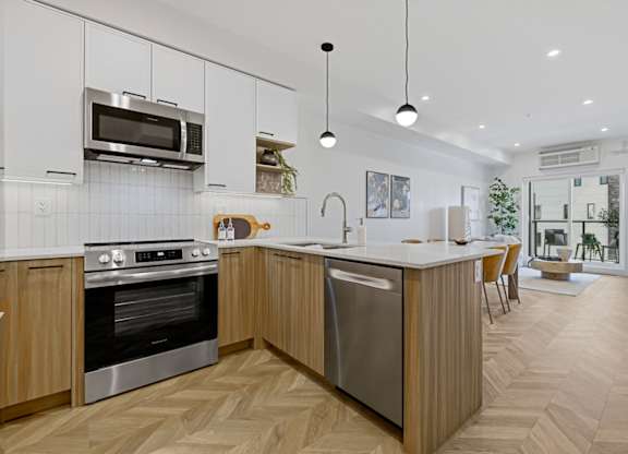 A modern kitchen with wooden cabinets and a large island.