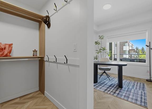 A room with a table and a window showing a building outside.