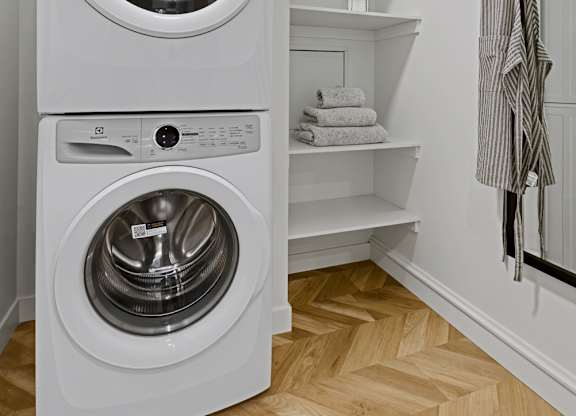 A white washing machine and dryer in a small laundry room.