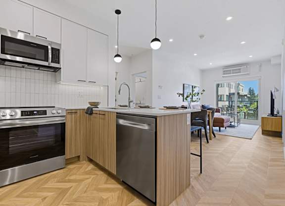 A modern kitchen with wooden cabinets and stainless steel appliances.