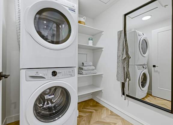 A white washing machine and dryer in a small laundry room.
