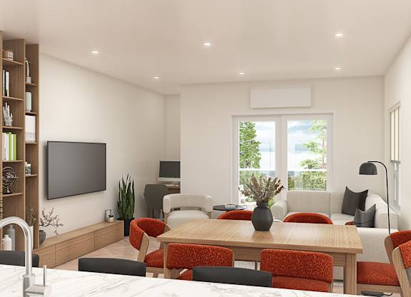 A modern living room with a wooden dining table and red chairs.