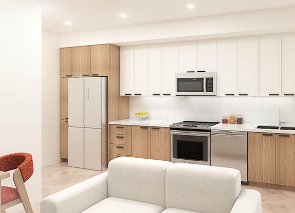 A modern kitchen with a white couch and wooden cabinets.
