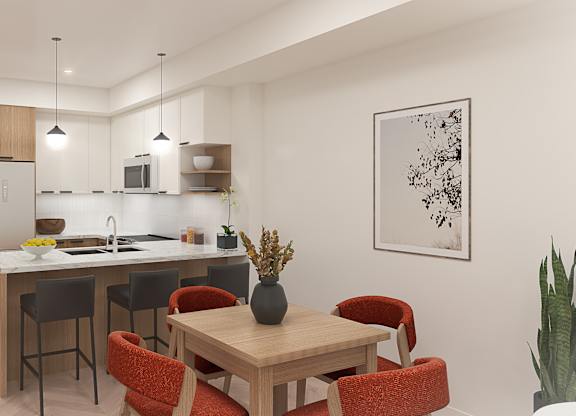 A modern kitchen with a dining table and chairs.