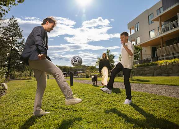 Two men playing frisbee in a sunny park.