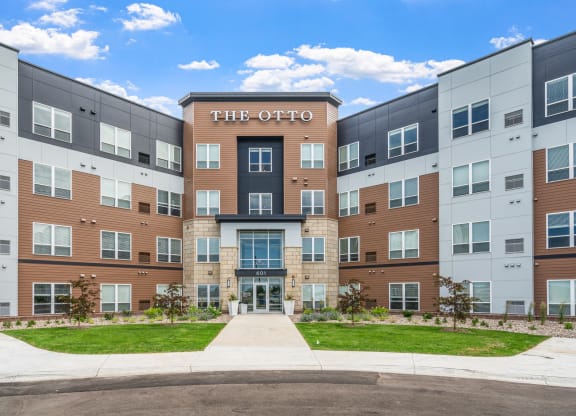 an apartment building with a sidewalk in front of it