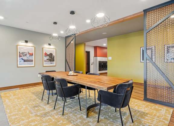 A conference room with a long table and chairs.