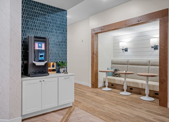 a living room with a coffee machine and a seating area
