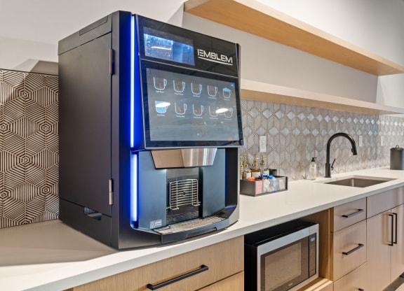 a kitchen with a coffee machine on the counter and a sink