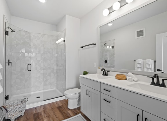 a white bathroom with a shower and a sink