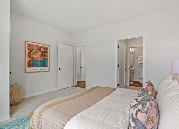 a bedroom with a bed and a door to a bathroom