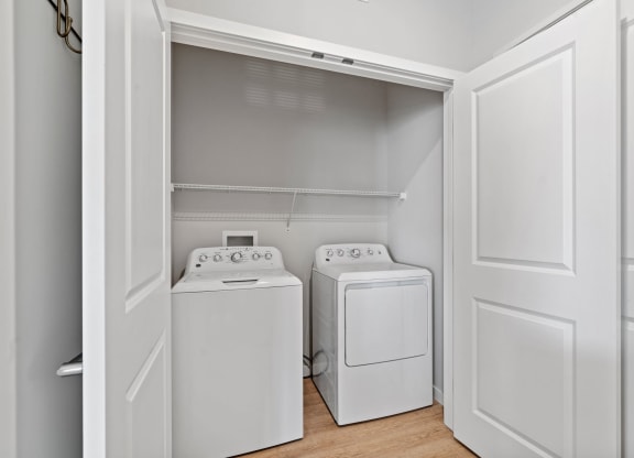 a washer and dryer in a laundry room with white doors