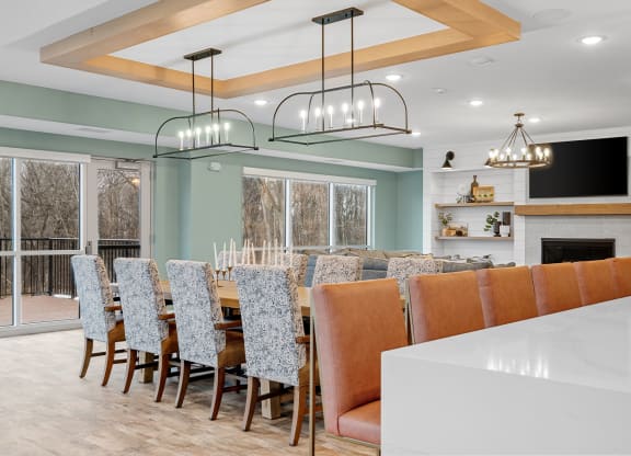 a large dining room with a long table and chairs and a fireplace